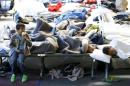 Migrants rest at an temporary shelter in a sports hall in Hanau
