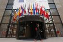 A woman walks past the entrance of the European Council headquarters in Brussels