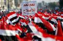 Supporters of prominent Iraqi Shi'ite cleric Moqtada al-Sadr shout slogans during a protest against corruption at Tahrir Square in Baghdad