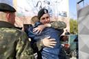 Ukrainian marines say farewell outside a Ukrainian military base in the Crimean port city of Feodosia
