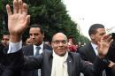 Tunisian President and presidential candidate Moncef Marzouki waves to supporters in Tunis on December 9, 2014