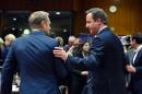 European Council president Donald Tusk (L) speaks with British Prime Minister David Cameron in Brussels on December 17, 2015
