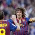 Barcelona's Puyol and Iniesta celebrate a goal against Malaga during their Spanish First division soccer match at Camp Nou stadium in Barcelona