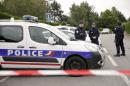 French police cordon off a street in Magnanville after a man claiming allegiance to the Islamic State group killed two people on June 13, 2016