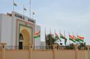 Flags fly at half mast in front of the Parliament in Niamey on November 1, 2013