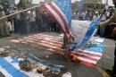 Iranian protestors set US and Israeli flags afire during a parade marking al-Quds (Jerusalem) Day in Tehran on July 1, 2016