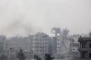 Smoke rises after what activists said was an airstrike by forces loyal to Syria's President Bashar al-Assad in eastern Al-Ghouta, near Damascus