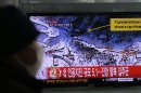 A South Korean watches news reporting about a possible nuclear test conducted by North Korea on a TV screen at the Seoul train station in Seoul, South Korea, Tuesday, Feb. 12, 2013. The U.S. Geological Survey said Tuesday it had detected a magnitude 4.9 earthquake in North Korea, but neither Pyongyang nor Seoul confirmed whether North Korea had conducted its widely anticipated third nuclear test. The writing reads "North, Artificial earthquake 5.1." (AP Photo/Lee Jin-man)