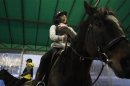 A 14-year old girl, who preferred to be identified only by her surname, Kim, rides a horse at Riding Healing Center in Incheon