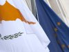 The Cypriot, left, and EU flag are seen at the Cypriot delegation building in Brussels on Sunday, March 24, 2013. The EU says a top official will chair a high-level meeting on Cyprus in a last-ditch effort to seal a deal before finance ministers decide whether the island nation gets a 10 billion euro bailout loan to save it from bankruptcy. (AP Photo/Virginia Mayo)