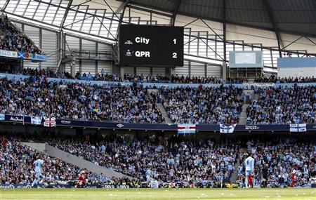 A score board shows the score at 90 minutes during Manchester City's English Premier League soccer match against Queens Park Rangers in Manchester