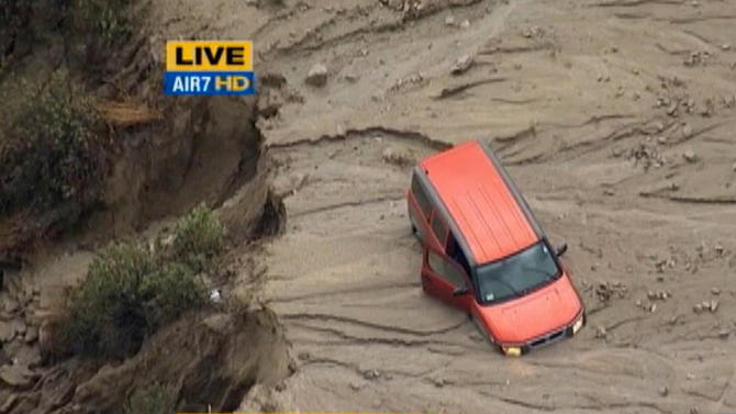 This image taken from video provided by KABC-TV, shows a vehicle stuck along a muddy road in the mountainous community of Green Valley, Calif., about 65 miles northwest of downtown Los Angeles on Thursday, Oct. 15, 2015. Flash flooding in northern Los Angeles County has filled several roads with mud, stranding vehicles and blocking traffic on one of the state’s main highways. (KABC-TV via AP) MANDATORY CREDIT; TV OUT