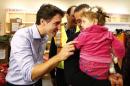 Syrian refugees are greeted by Canada's Prime Minister Justin Trudeau on their arrival from Beirut at the Toronto Pearson International Airport