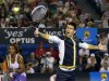 Novak Djokovic of Serbia hits a return as Serena Williams of the U.S. looks on during Kids Tennis Day at the Australian Open tennis tournament in Melbourne