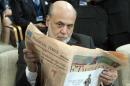 Ben Bernanke, chairman of the Federal Reserve, reads a newspaper before a meeting of the IMFC, during the World Bank/IMF Annual Meetings at IMF headquarters, Saturday, Oct. 12, 2013, in Washington. World finance officials prepared to wrap up three days of meetings in Washington, where fretting about the risk of an unprecedented U.S. debt default overshadowed myriad worries about a shaky global economic recovery. ( AP Photo/Jose Luis Magana)