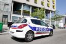 A police vehicle is parked outside the student residence where an It student -- suspected of planning an attack on churches -- lived in Paris, on April 22, 2015
