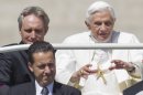 In this photo taken Wednesday, May, 23, 2012, Pope Benedict XVI, flanked by his private secretary Georg Gaenswein, top left, and his butler Paolo Gabiele arrives at St.Peter's square at the Vatican for a general audience. The Vatican has confirmed Saturday, May 26, 2012, Gabriele was arrested in an embarrassing leaks scandal. Spokesman the Rev. Federico Lombardi said Paolo Gabriele was arrested in his home inside Vatican City with secret documents in his possession. Gabriele, a layman, was being held. Vatican documents leaked to the press in recent months have pointed to power struggles and accusations of corruption touching senior Vatican cardinals. (AP Photo/Andrew Medichini)