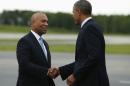 U.S. President Barack Obama shakes hands with Massachusetts Governor Deval Patrick upon arrival in Worcester