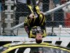 Carl Edwards performs a flip in front of his crew as he celebrates winning the NASCAR Sprint Cup Series auto race, Sunday, March 3, 2013, in Avondale, Ariz. (AP Photo/Ross D. Franklin)