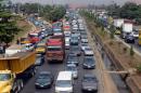 Motorists queue in a long traffic jam in Lagos on January 21, 2014