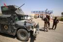 Members of the Iraqi counter-terrorism forces stand next to an armed vehicle on June 23, 2016