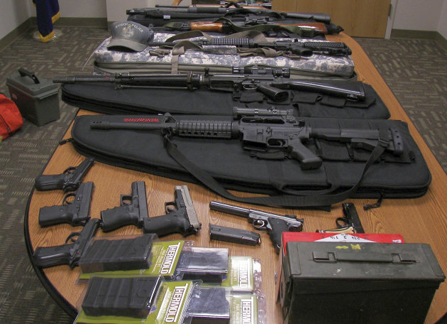 This undated photograph released by the Maine State Police shows weapons gathered from the home and vehicle of Timothy Courtois, of Biddeford, Maine, who was arrested Sunday, July 22, 2012 on charges of having a concealed weapon and speeding on the Maine Turnpike. Found in his car were an assault weapon, four handguns and several boxes of ammunition.  A search of his home revealed several additional weapons, including a machine gun, and thousands of rounds of ammunition. Courtois told authorities he was on his way to Derry, N.H., to shoot a former employer. He also said he had attended the Batman movie the previous night. (AP Photo/Maine State Police)