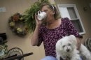 CORRECTS TYPE OF MENINGITIS TO FUNGAL INSTEAD OF BACTERIAL - Patsy Bivins, 68 of Sturgis, Ky., drinks coffee while sitting on her porch with her dog Little Britches at her apartment in Sturgis, Ky., Friday, October 5, 2012. Bivins was injected with steroids at St. Mary Sugricare in Evansville, Ind., who notified her of possibly being infected with fungal Meningitis. (AP Photo/Stephen Lance Dennee)