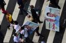 Supporters cross the street with banners of presidential candidate Marina Silva in Rio de Janeiro on September 24, 2014