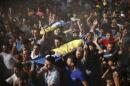 Palestinians carry bodies of two boys from Baker family, whom medics said were killed with other two children from same family by a shell fired by an Israeli naval gunboat, during their funeral in Gaza City