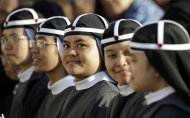 A group of nuns from the Philippines wait for the start of a canonization ceremony celebrated by Pope Benedict XVI, in St. Peter's Square, at the Vatican, Sunday, Oct. 21, 2012. The pontiff will canonize seven people, Kateri Tekakwitha, Maria del Carmen, Pedro Calungsod, Jacques Berthieu, Giovanni Battista Piamarta, Mother Marianne Cope, and Anna Shaeffer. (AP Photo/Andrew Medichini)