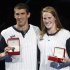 Michael Phelps and Missy Franklin pose with watches given to them as the best performers at the U.S. Olympic swimming trials, in Omaha