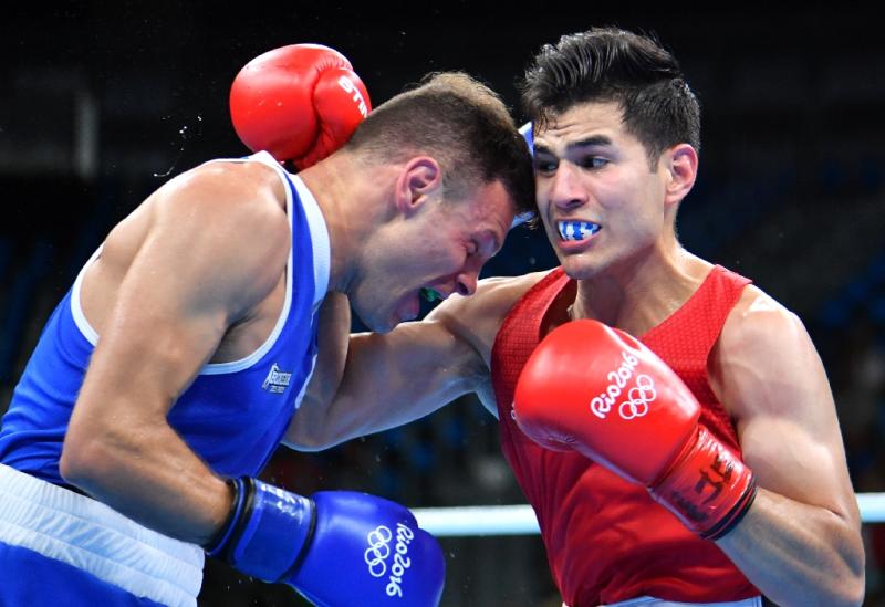 Italy's Carmine Tommasone (L), pictured fighting Mexico's Lindolfo Delgado during the Men's Light (60kg) match at the 2016 Olympic Games in Rio de Janeiro on August 6, 2016, simply had too much speed, power, and guile for Delgado (AFP Photo/Yuri Cortez )