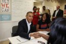 U.S. President Barack Obama shakes hands with volunteers in his campaign field office in Orlando
