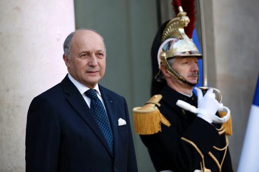 French Minister of Foreign Affairs Laurent Fabius poses as he arrives at the Elysee Presidential palace on December 5, 2013 in Paris, to attend a meeting with French President and Algerian Prime Minister