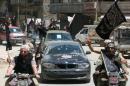 Fighters from Al-Qaeda's Syrian affiliate Al-Nusra Front drive in the northern Syrian city of Aleppo on May 26, 2015