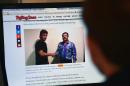 A man reads an article about drug lord Joaquin Guzman, aka "El Chapo", showing a picture of him (R) and US actor Sean Penn, on the website of Rolling Stone magazine, in Mexico City, on January 10, 2016