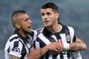 Juventus' Alvaro Morata, foreground, celebrates with teammates Arturo Vidal, left, and Stefano Sturaro after scoring the opening goal during the Champions League, semifinal match between Juventus and Real Madrid at the Juventus Stadium in Turin, Italy, Tuesday, May 5, 2015. (Alessandro Di Marco/ANSA via AP)