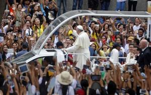 Pope Francis waves to well-wishers aboard the popemobile …