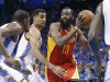 Houston Rockets guard James Harden (13) drives past Oklahoma City Thunder forward Kevin Durant, left, and guard Thabo Sefolosha during the first quarter of Game 5 of a first-round NBA basketball playoff series in Oklahoma City, Wednesday, May 1, 2013. (AP Photo/Sue Ogrocki)