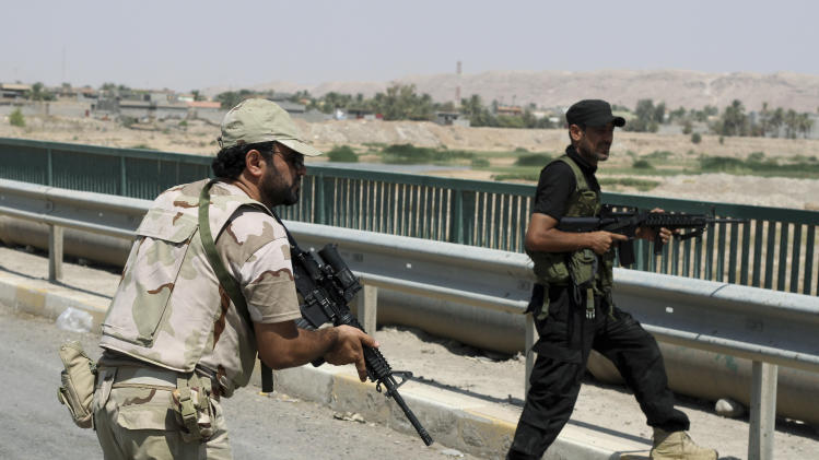 Iraqi security forces and Shiite militiamen patrol in Amirli, some 105 miles (170 kilometers) north of Baghdad, Iraq, Sunday, Aug. 31, 2014. Iraqi security forces and Shiite militiamen on Sunday broke a six-week siege imposed by the Islamic State extremist group on the northern Shiite Turkmen town of Amirli, following U.S. airstrikes against the Sunni militants' positions, officials said. (AP Photo)