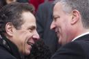 New York City Mayor Bill de Blasio greets New York Governor Andrew Cuomo after his inauguration ceremony in New York