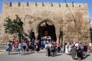 People walk in front of the Naryn-Kala Fortress in Derbent, where a shooting at the UNESCO heritage site killed one and injured 11 on December 30, 2015