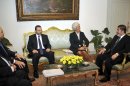 In this image released by the office of the Egyptian Presidency, International Monetary Fund Chief Christine Lagarde, second right, meets with Egyptian President Mohammed Morsi, right, in Cairo, Egypt, Wednesday, Aug. 22, 2012. Egypt's prime minister says his country has formally asked the International Monetary Fund for a $4.8 billion loan to help boost its battered economy, and that he expects to reach a deal by the end of the year. (AP Photo/Egyptian Presidency)