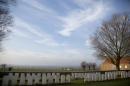 In this Dec. 12, 2013 file photo, World War I graves next to a farm on Messines Ridge in Messines, Belgium. The ridge was fought over fiercely by all sides during the entire four years of the war. One hundred years on World War I still resonates across Flanders Fields, where countless monuments and cemeteries as well as the relics of bunkers and trenches dot the modern landscape. (AP Photo/Virginia Mayo, File)