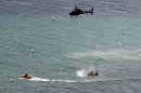 Police in inflatable rubber boats shoot at a shark off Muriwai Beach near Auckland, New Zealand, Wednesday, Feb. 27, 2013, as they attempt to retrieve a body following a fatal shark attack. Police said a man was found dead in the water after being 