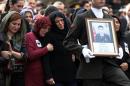 Family members attend funeral prayers for Turkish army officer Seckin Cil, who was killed in Sur, Diyarbakir Wednesday, in Ankara, Turkey, Thursday, Feb. 18, 2016. Six soldiers were killed after PKK rebels detonated a bomb on the road linking the cities of Diyarbakir and Bingol in southeastern Turkey as their vehicle was passing by, according to Turkey's state-run Anadolu Agency. The deaths come a day after a suicide bombing claimed the lives of at least 28 people and wounded dozens of others.(AP Photo/Burhan Ozbilici)