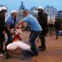 Plainclothed police detain a Polish fan during the Euro 2012 soccer championship group a match between Poland and Russia in downtown Warsaw, Poland , Tuesday, June 12, 2012. (AP Photo/Czarek Sokolowski)