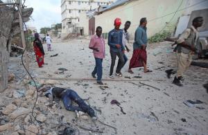Somalis walk past a dead civilian outside the hotel &hellip;