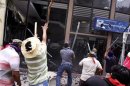 A group of teachers attack the offices of the National Action Party (PAN) to protest against an education overhaul in Chilpancingo