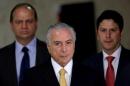 Brazil's interim President Temer, accompanied by Brazil's Health Minister Barros and Minister of Cities Araujo, arrives for a ceremony for the new rules of the program "Minha Casa Minha Vida" at the Planalto Palace in Brasilia